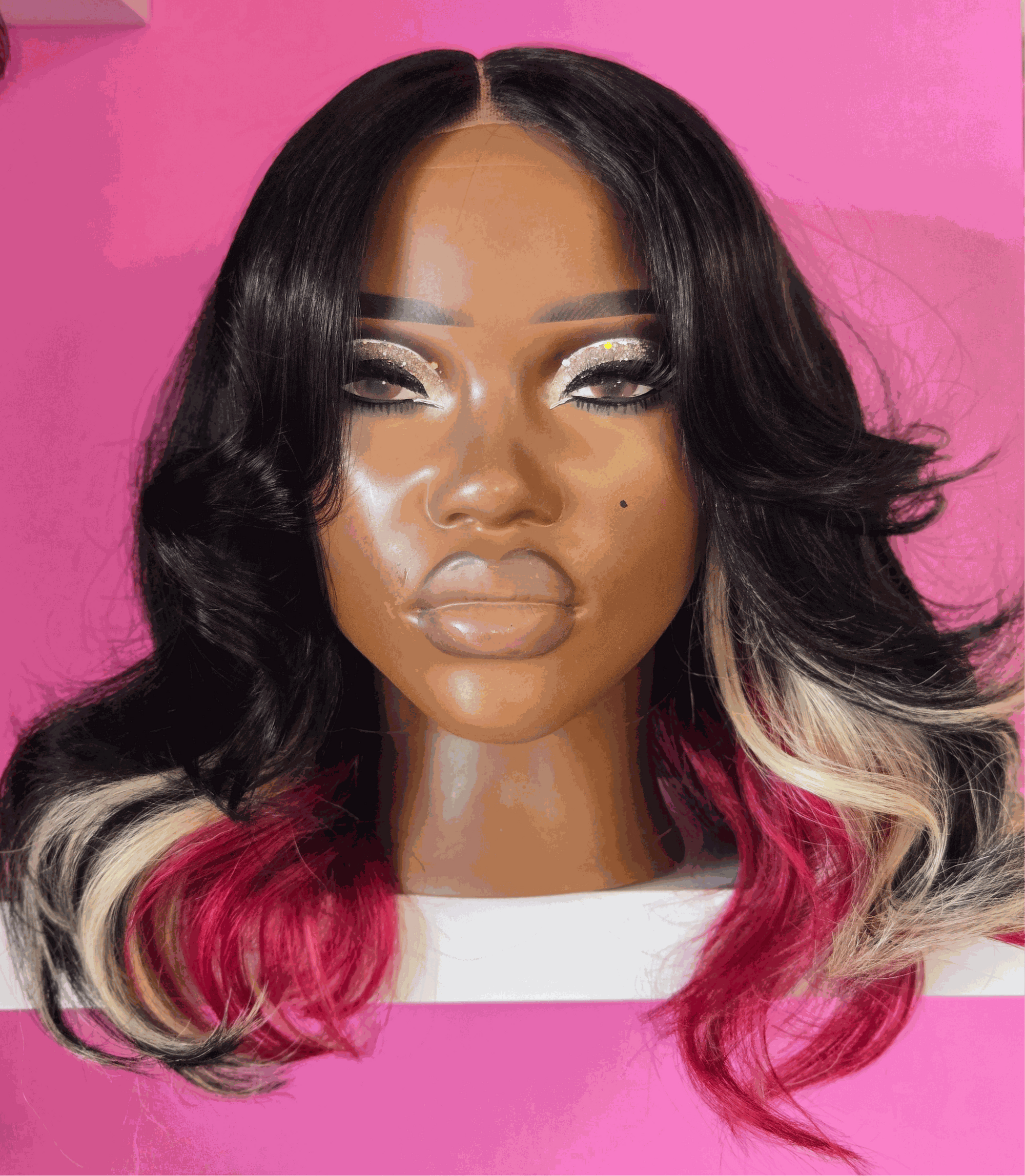 21” Canvas head wig with black, blonde, and red hair, middle part, pre-plucked, 2x6 transparent lace closure on small canvas head against pink background